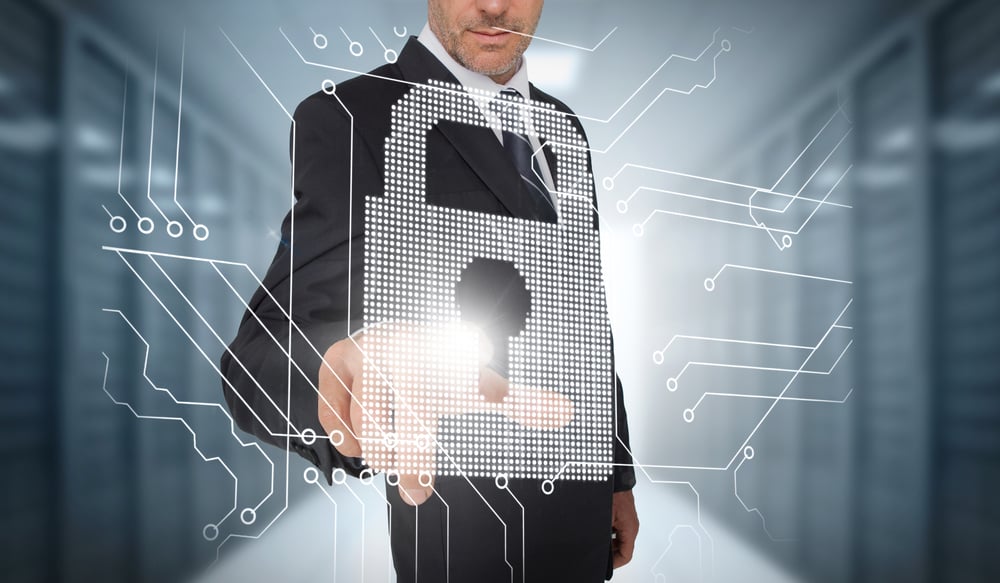 Businessman selecting a futuristic padlock with a data center on the background-1