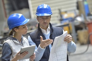 Engineers in mechanical factory reading instructions-2