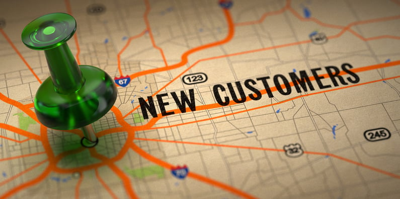 New Customers Concept - Green Pushpin on a Map Background with Selective Focus.